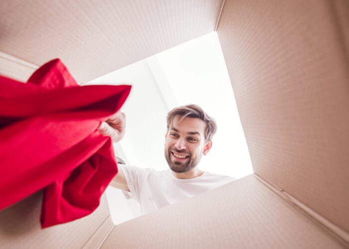 man-holding-shirt-inside-bottom-box-view